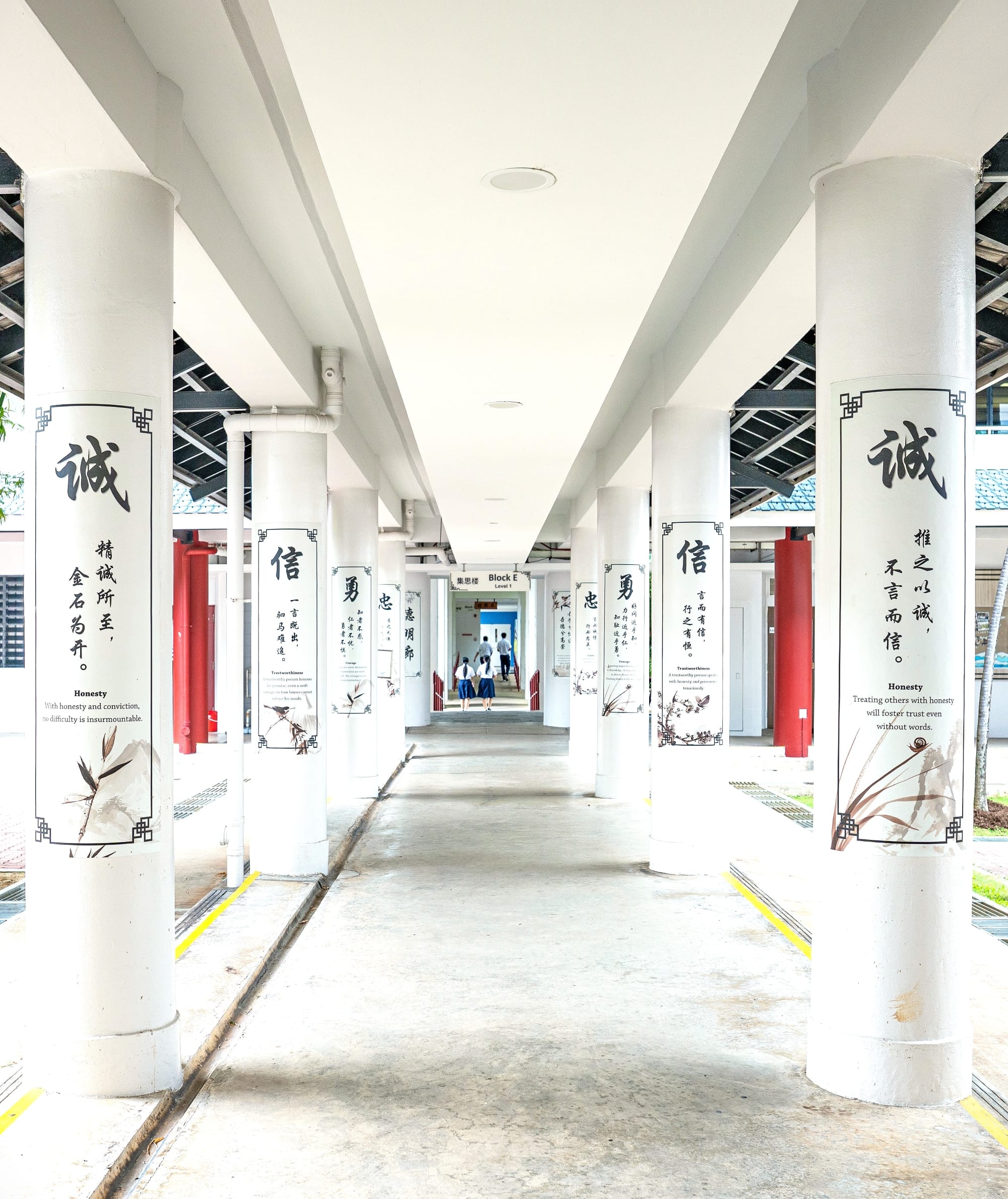 School walkway with school values on the pillars
